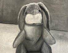 A black and white crayon drawing of a fuzzy bunny plush toy.