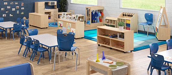 Early childhood classroom with tables, chairs, bookshelves, and more.