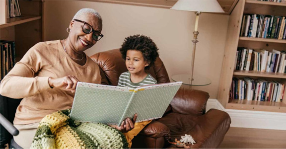 Adult with child reading a book