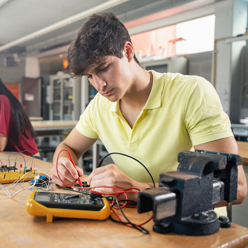 Young adult testing electronics.